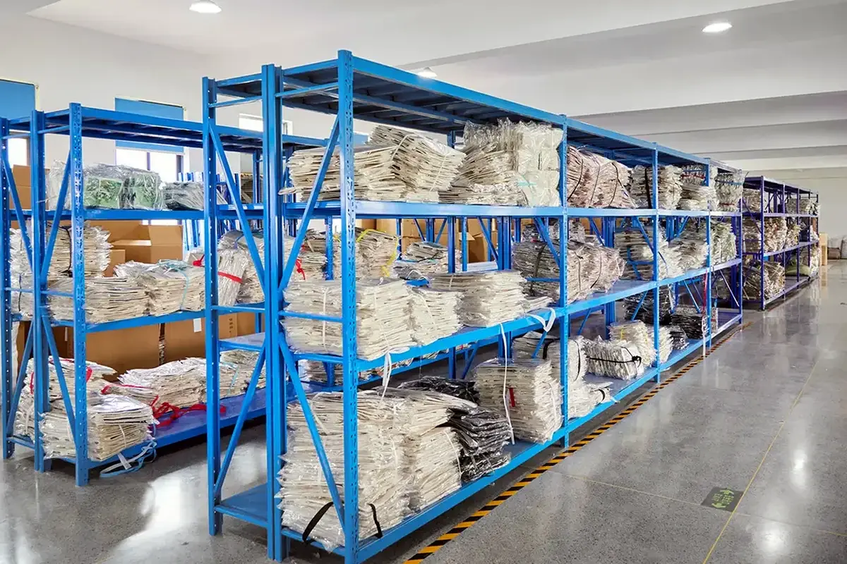 Packed tote bags organized on racks in the finished-goods warehouse.