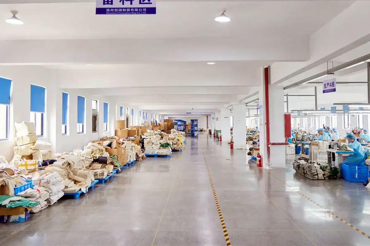 Prepared tote components staged beside an active factory production line.