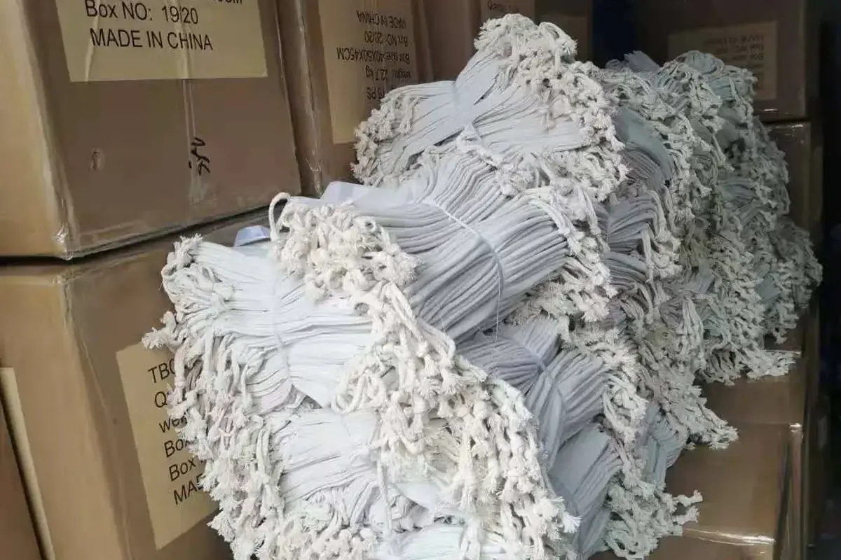 Bundled tote handles stacked on cartons before bulk packing.