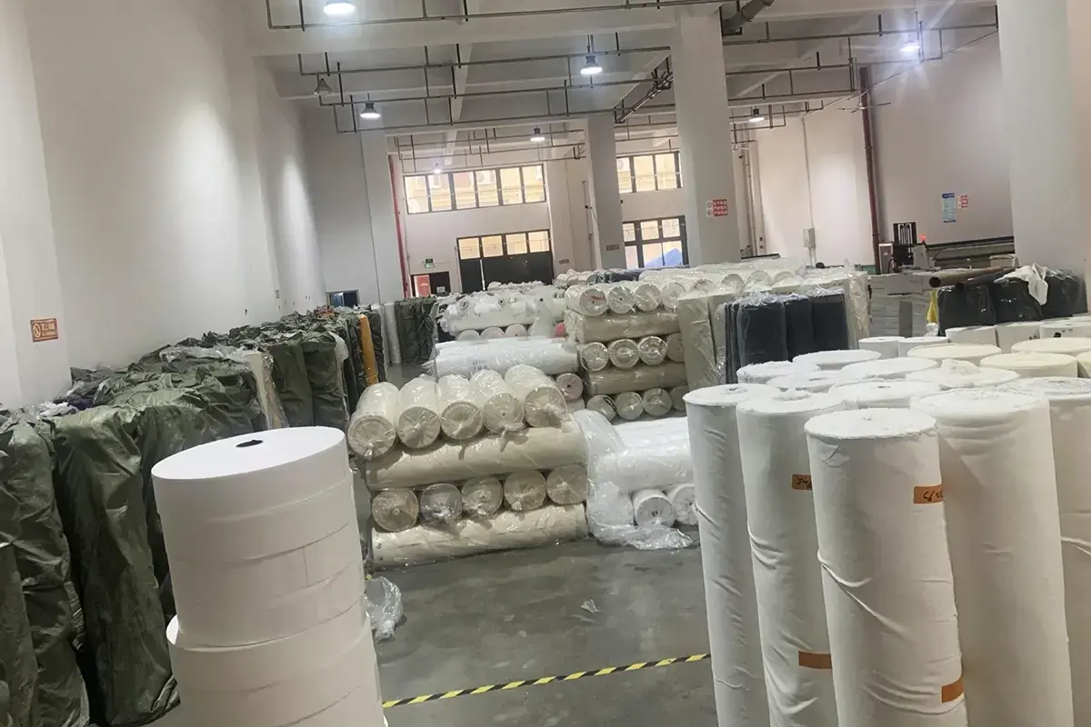 Fabric rolls stored for cotton and canvas tote bag material planning.