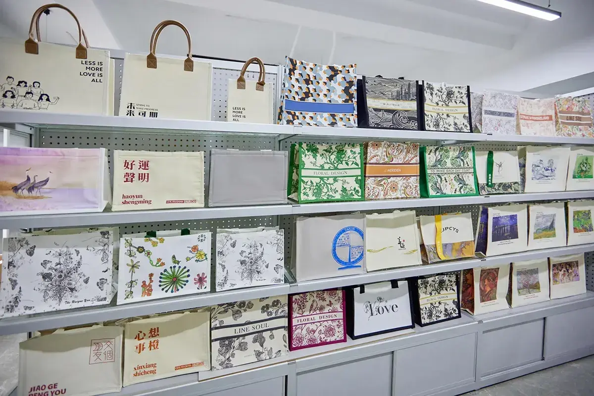 Tote material and print samples displayed for project specification review.