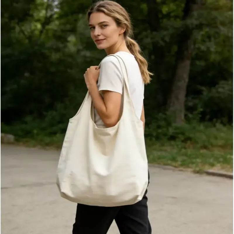 Woman carrying a natural 12 oz canvas tote outdoors.