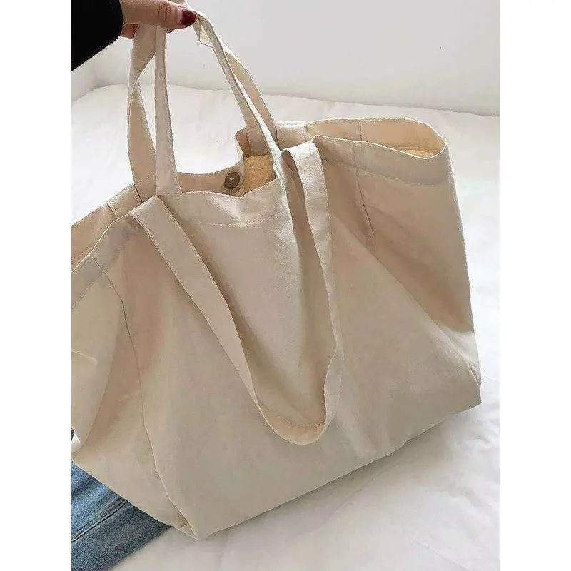Natural heavyweight canvas tote with a wide gusset and short handles.