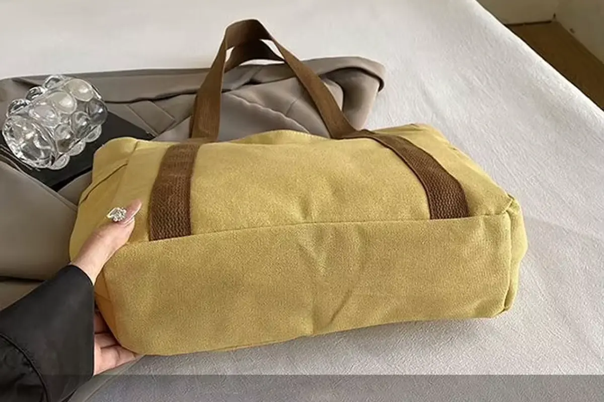 Close-up of a heavyweight canvas tote base reinforced with webbing.