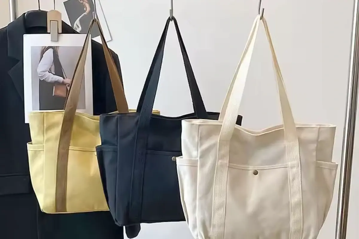 Three canvas totes with full-length reinforced webbing handles.