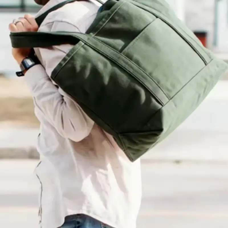 Dark green gusseted canvas tote with a closed top zipper.
