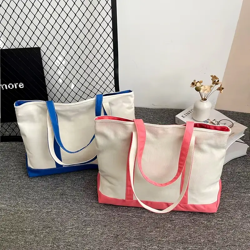 Two white canvas tote bags with blue and pink top zipper trims.