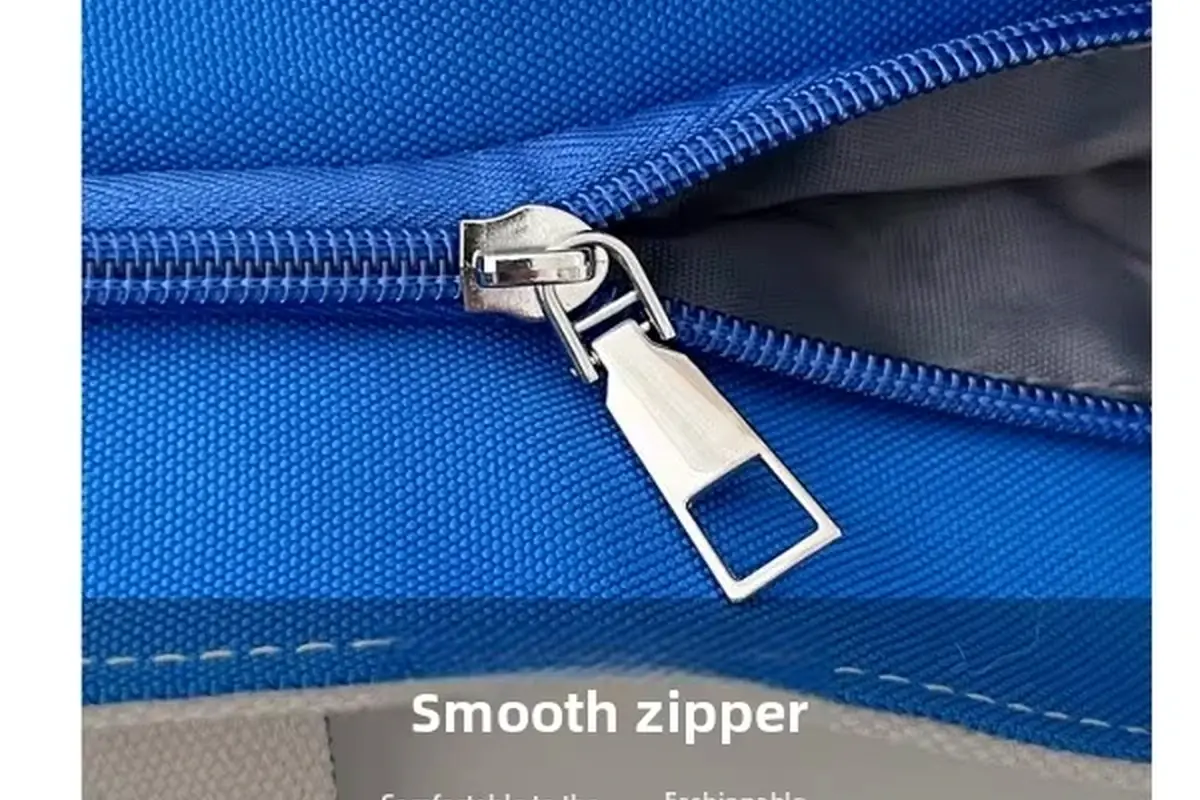 Close-up of a blue canvas tote zipper with a metal pull.