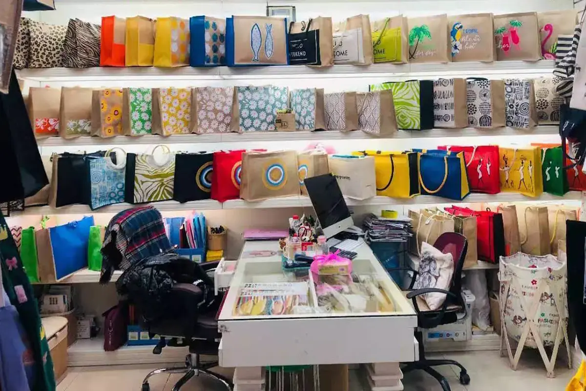 Tote bag samples in multiple colors and styles in the sample room.