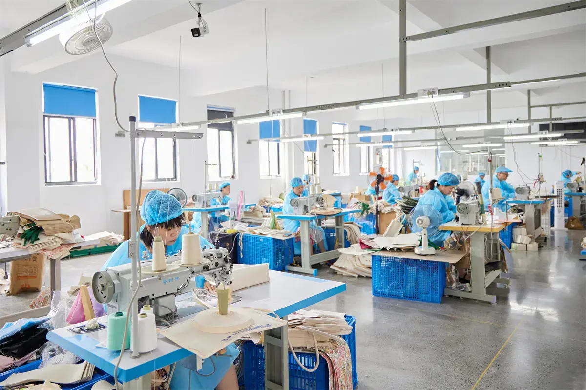 Workers sewing canvas tote bags in the Hangzhou workshop.