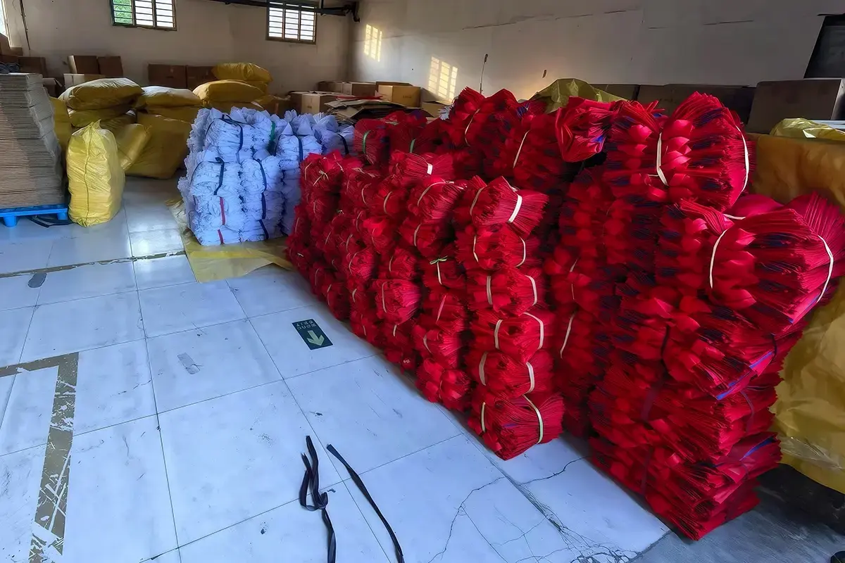 Bundled red tote bag components prepared for packing and delivery.