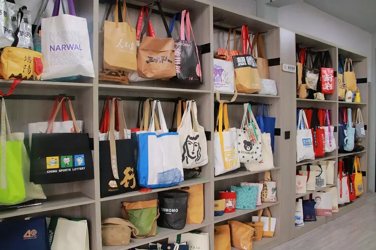 Finished custom tote bag samples arranged on showroom shelves.