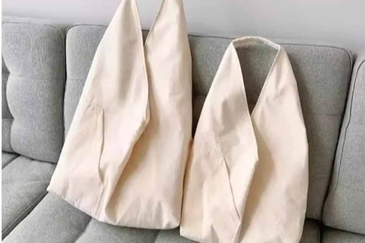 Natural canvas totes folded flat before carton packing