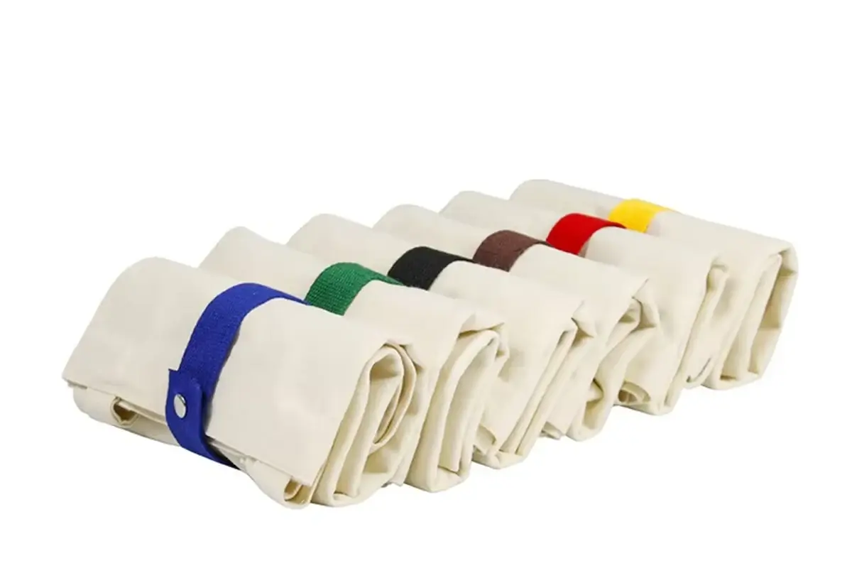 Folded canvas tote samples secured for packing review