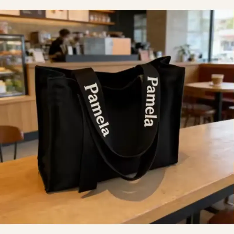 Black heavyweight canvas tote displayed upright on a counter