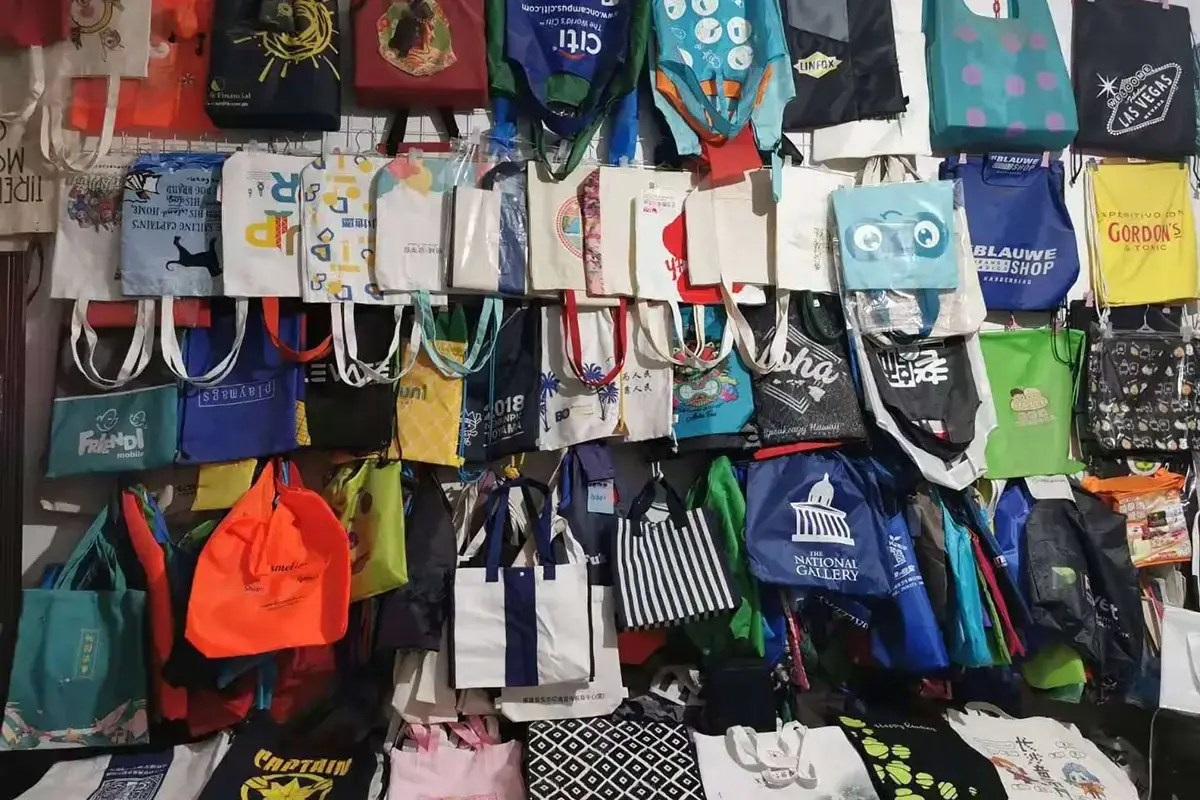 Factory sample wall used to compare canvas tote colors and builds