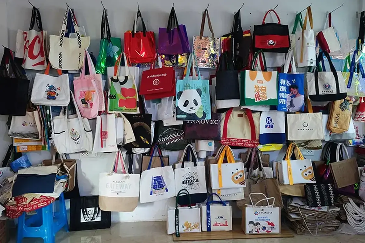 Canvas tote styles displayed together on a factory sample wall