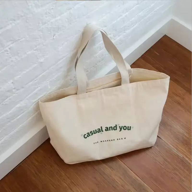 Natural canvas tote with short handles and a wide base