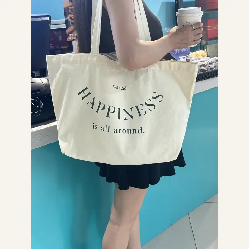 White heavyweight canvas tote carried by its short handles