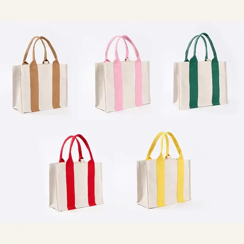 Five canvas tote bags with colored webbing handles