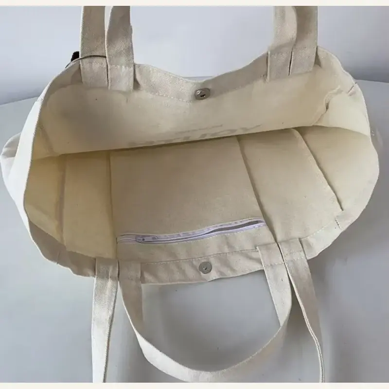 Canvas tote interior with zipper pocket and snap closure
