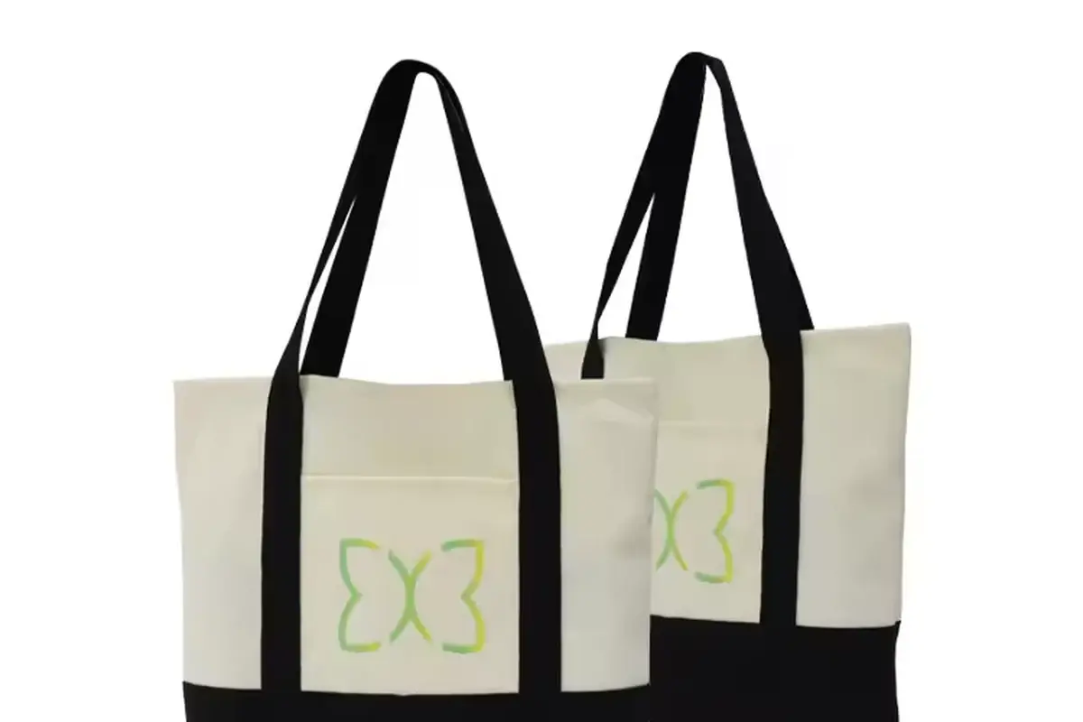 Two neutral canvas totes with black handles and contrast panels