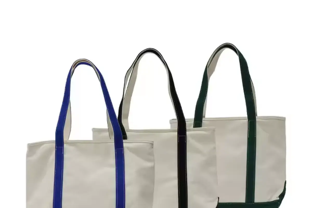 Three neutral canvas totes with blue black and green handles