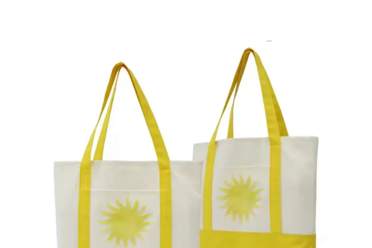 Two yellow canvas totes with long handles and sun artwork
