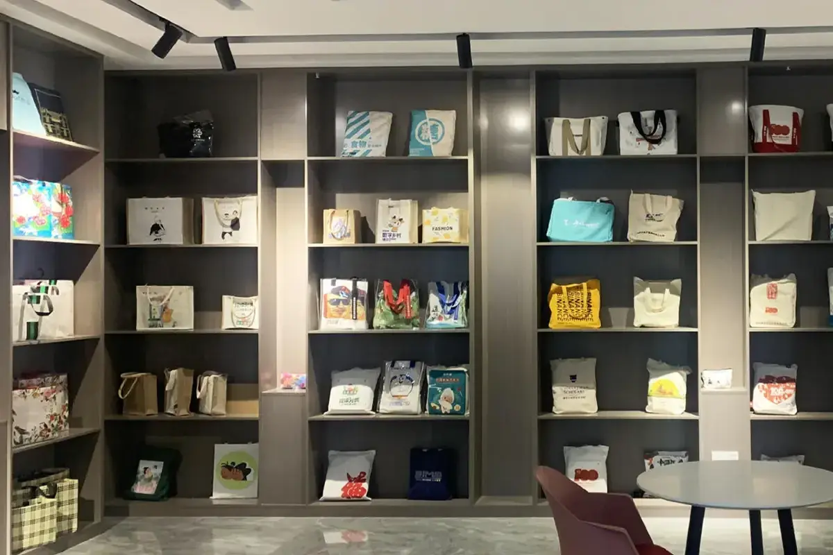 Custom tote bag samples arranged in the factory showroom
