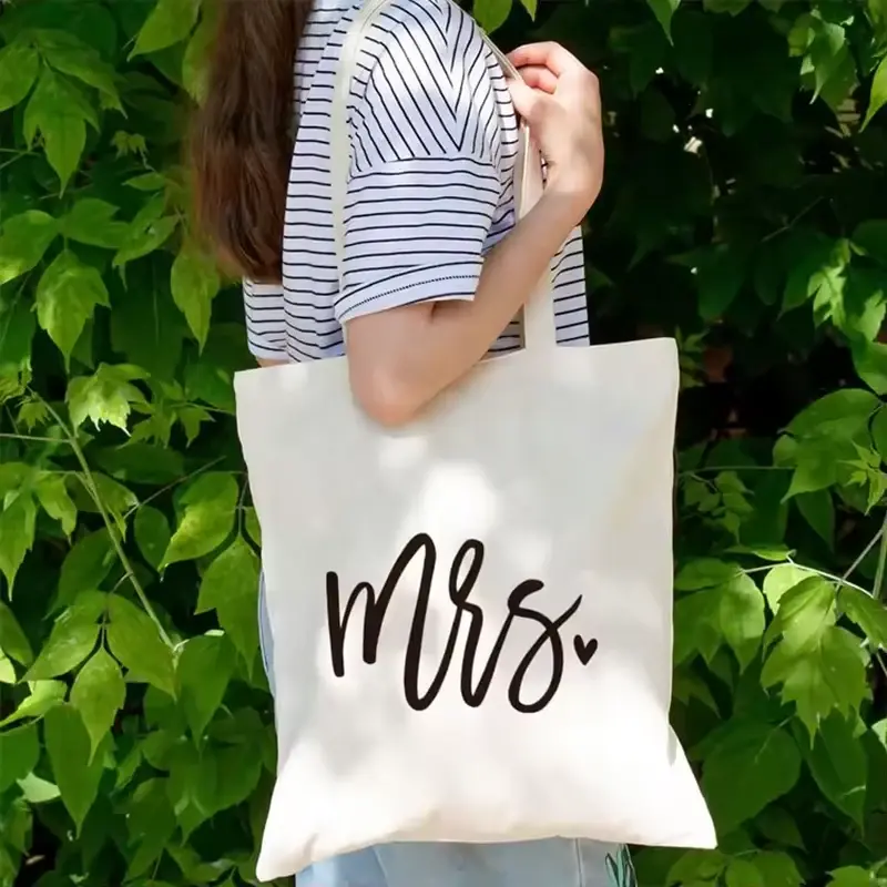 White cotton tote with long handles carried over the shoulder