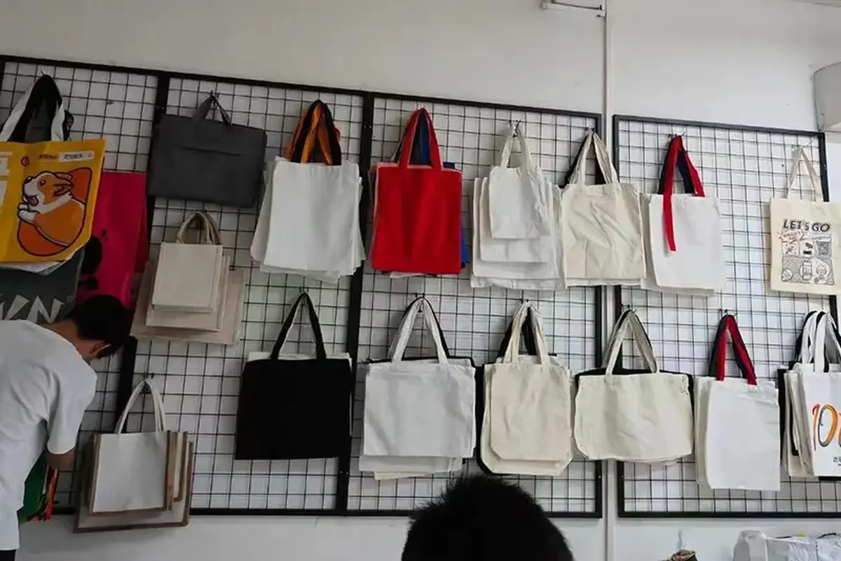 Canvas tote samples arranged for webbing handle style review