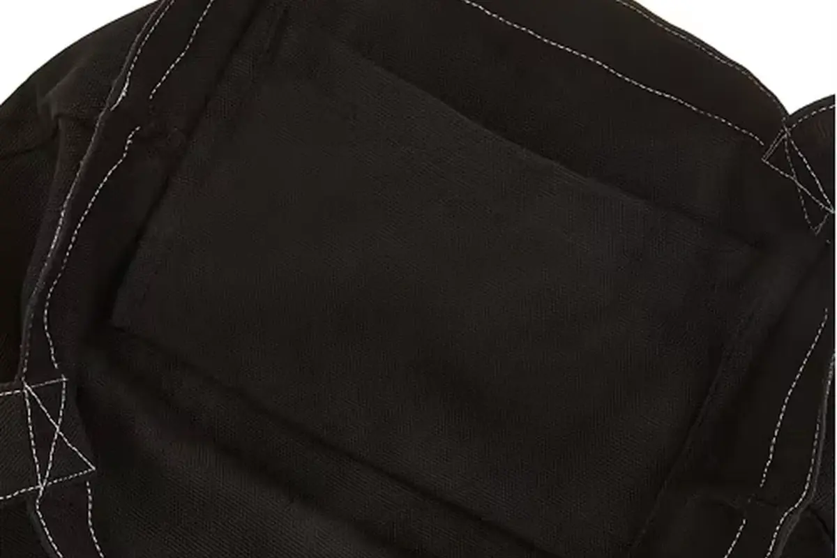 Black canvas tote interior showing pocket placement and seam lines
