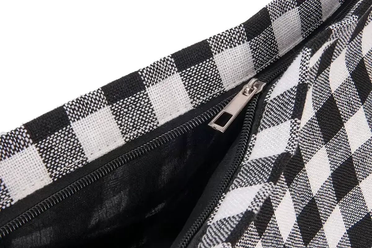 Close view of a checkered canvas tote showing the zipper opening and lining
