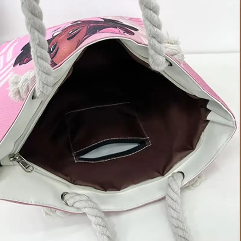 Pink printed canvas tote opened to show its inner pocket and lining