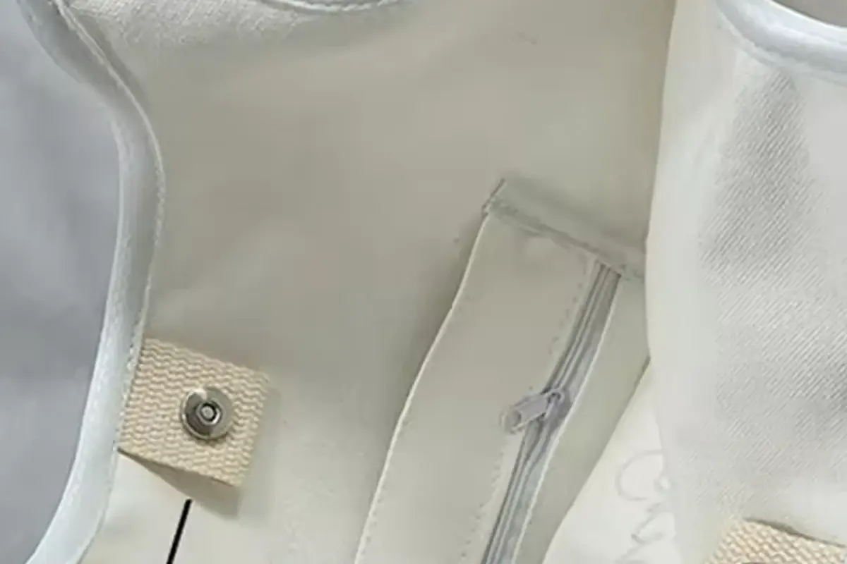 White canvas tote opened to inspect inner pocket and zipper access