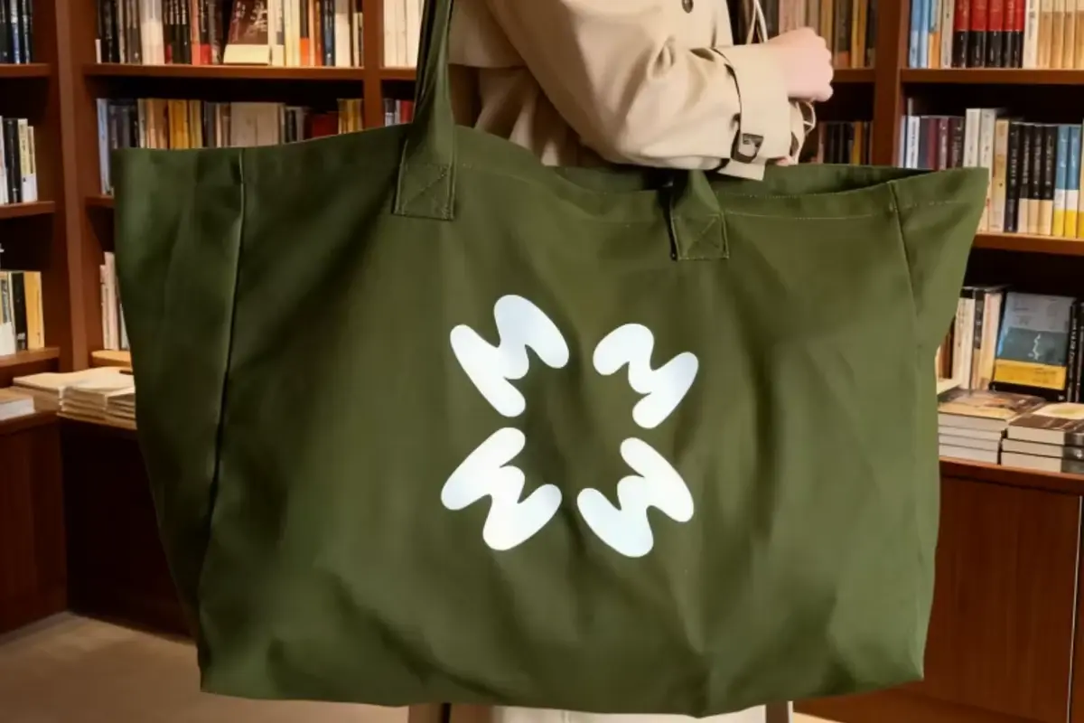 Olive cotton shopping tote with long handles and white leaf artwork