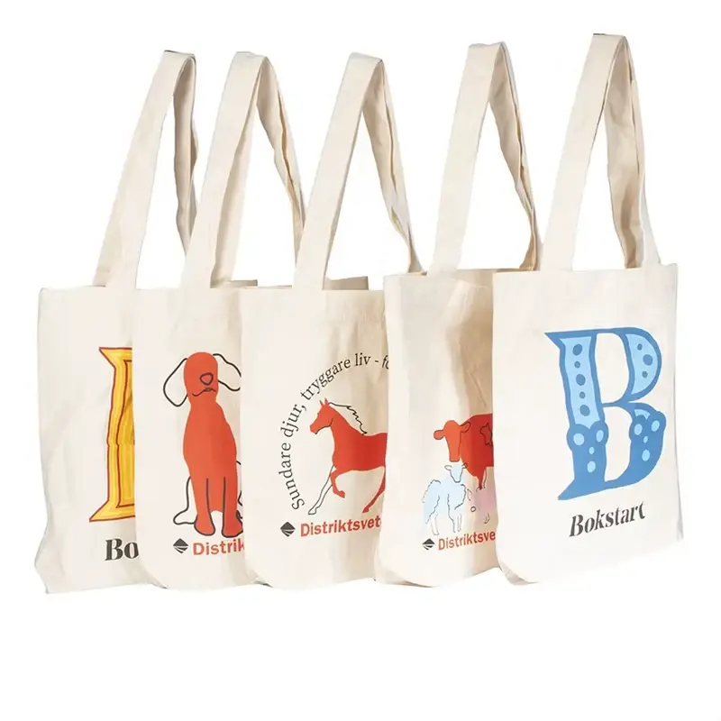 Four natural cotton shopping totes with colorful printed artwork