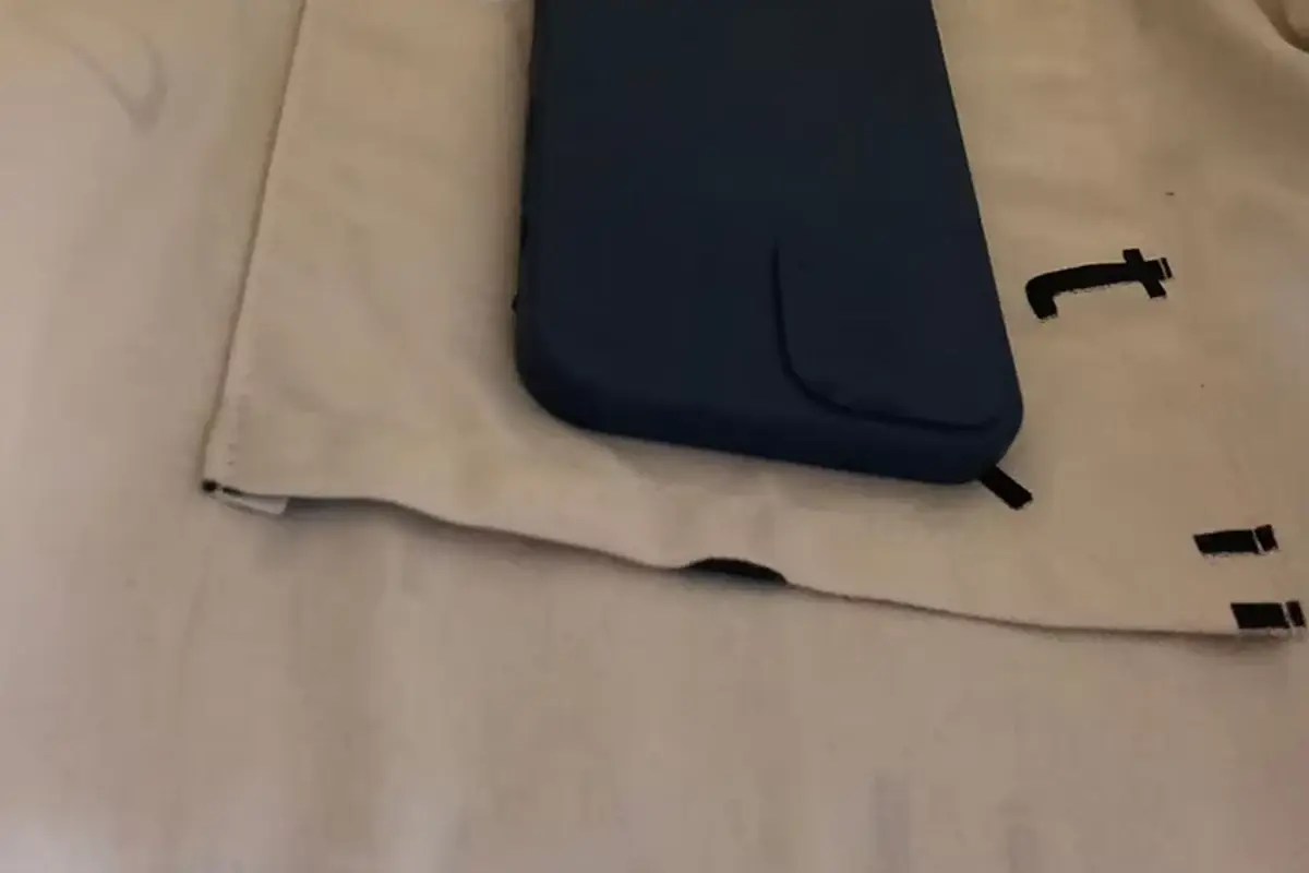 Black storage pouch resting inside a natural cotton shopping tote