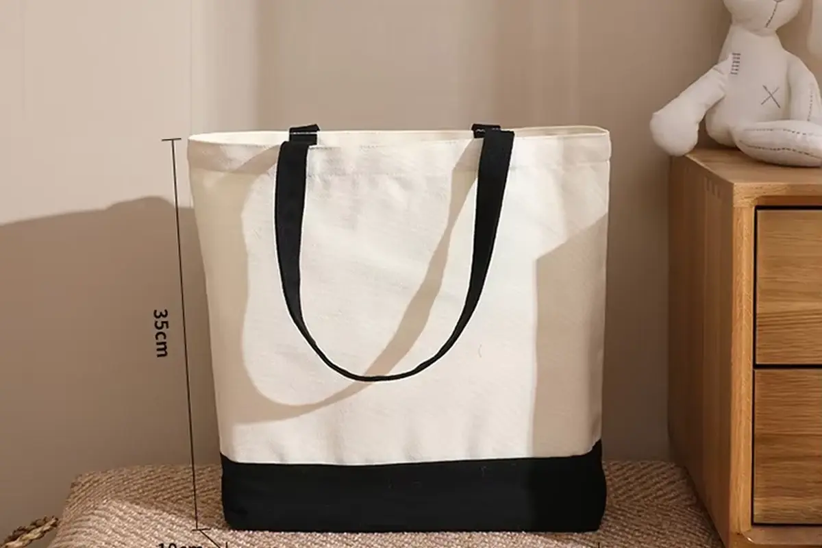 Natural cotton tote with black long handles and a clear print area