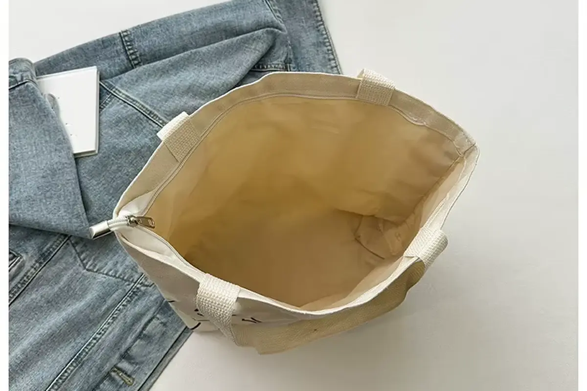 Open cotton tote showing the inner fabric and handle attachment