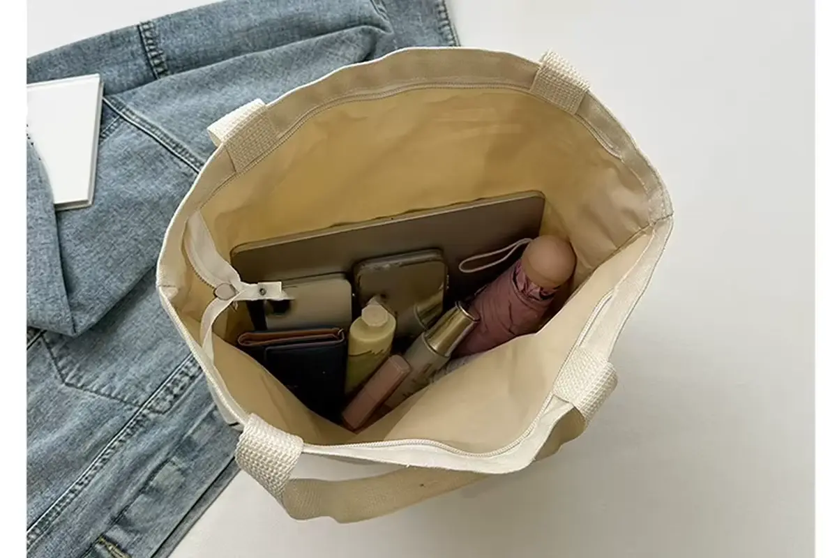 Open cotton tote showing long handle attachment and top stitching