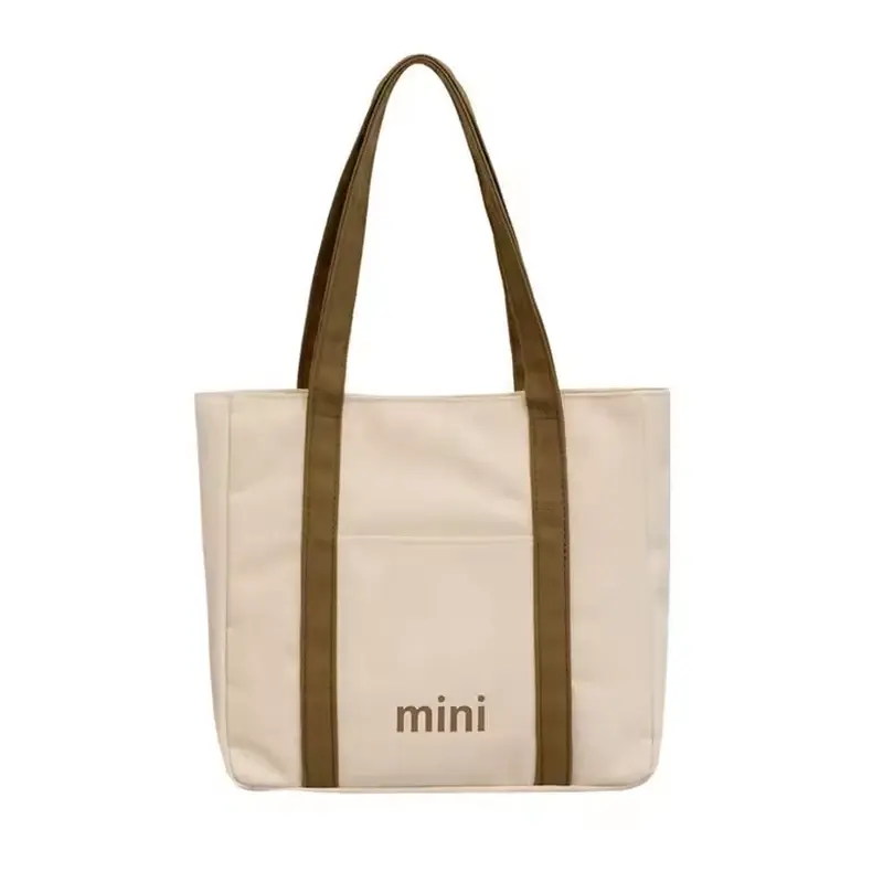 Natural cotton tote with long brown handles and a wide body