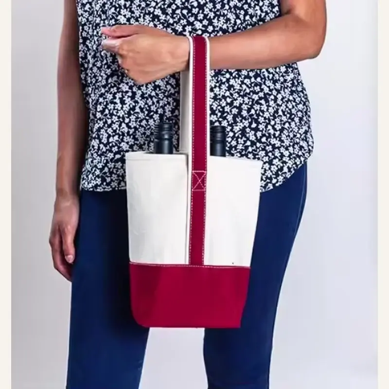 White canvas tote with red gusset carried by a model