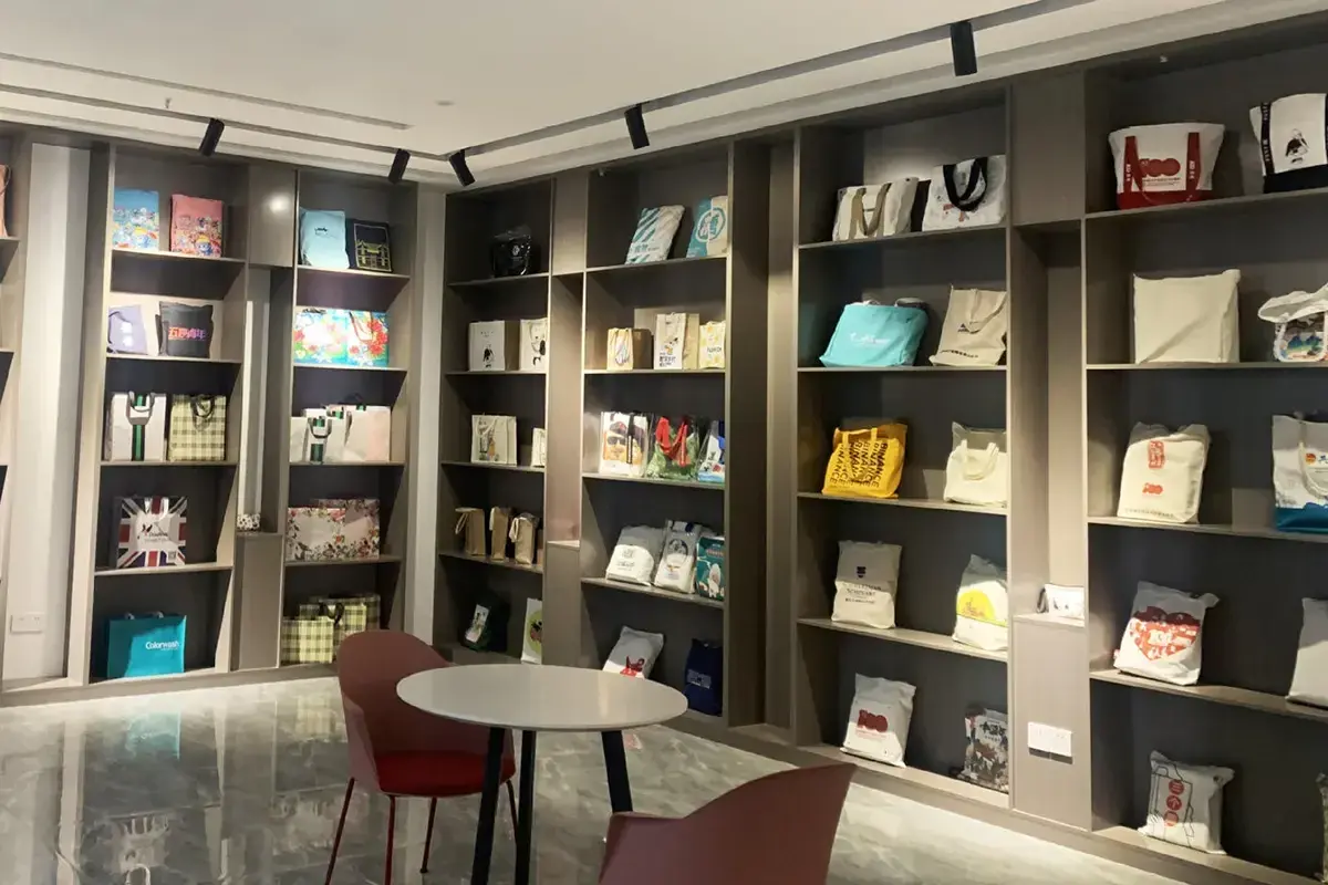 Custom tote bag samples arranged in the factory showroom