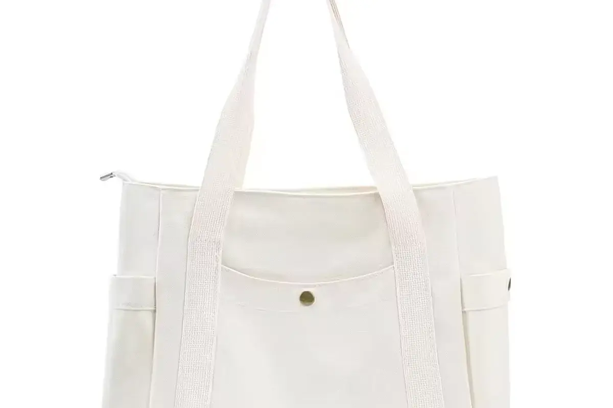 White canvas zipper tote with long handles and outer pockets