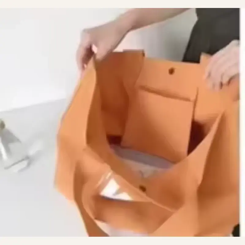Orange canvas zipper tote opened to show its interior storage