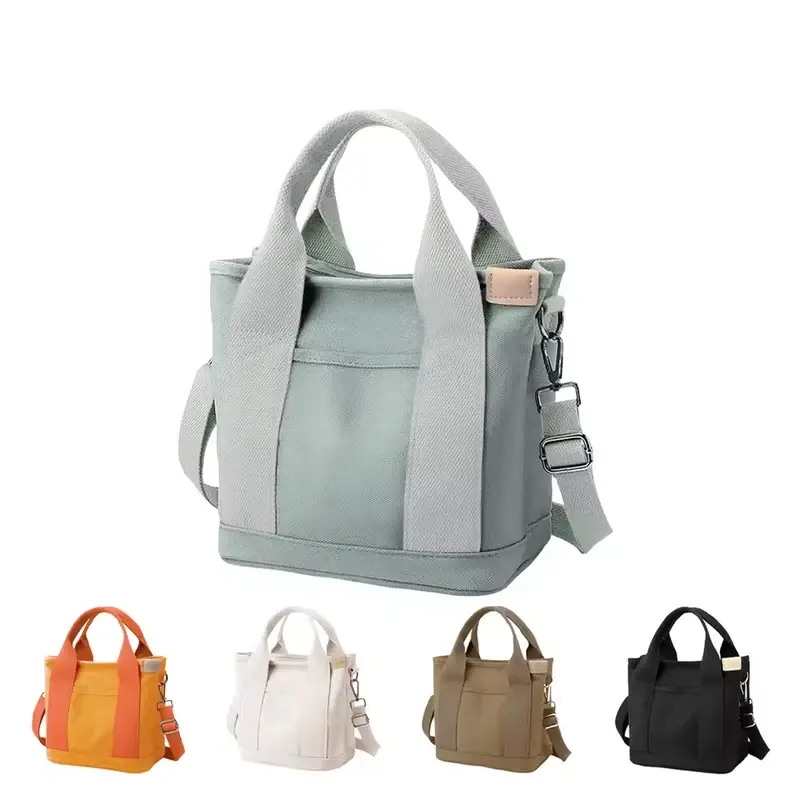 Sage canvas tote with a top zipper and detachable shoulder strap