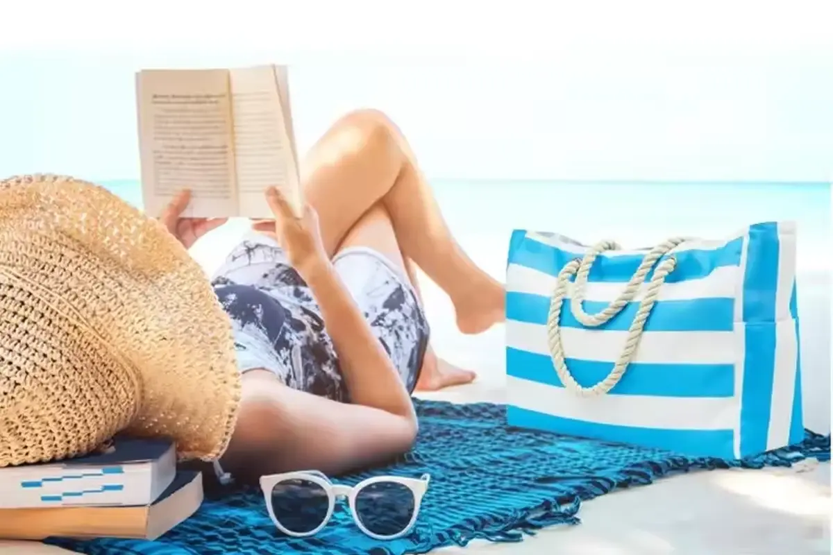 Blue striped zipper tote shown in a beach carrying scene