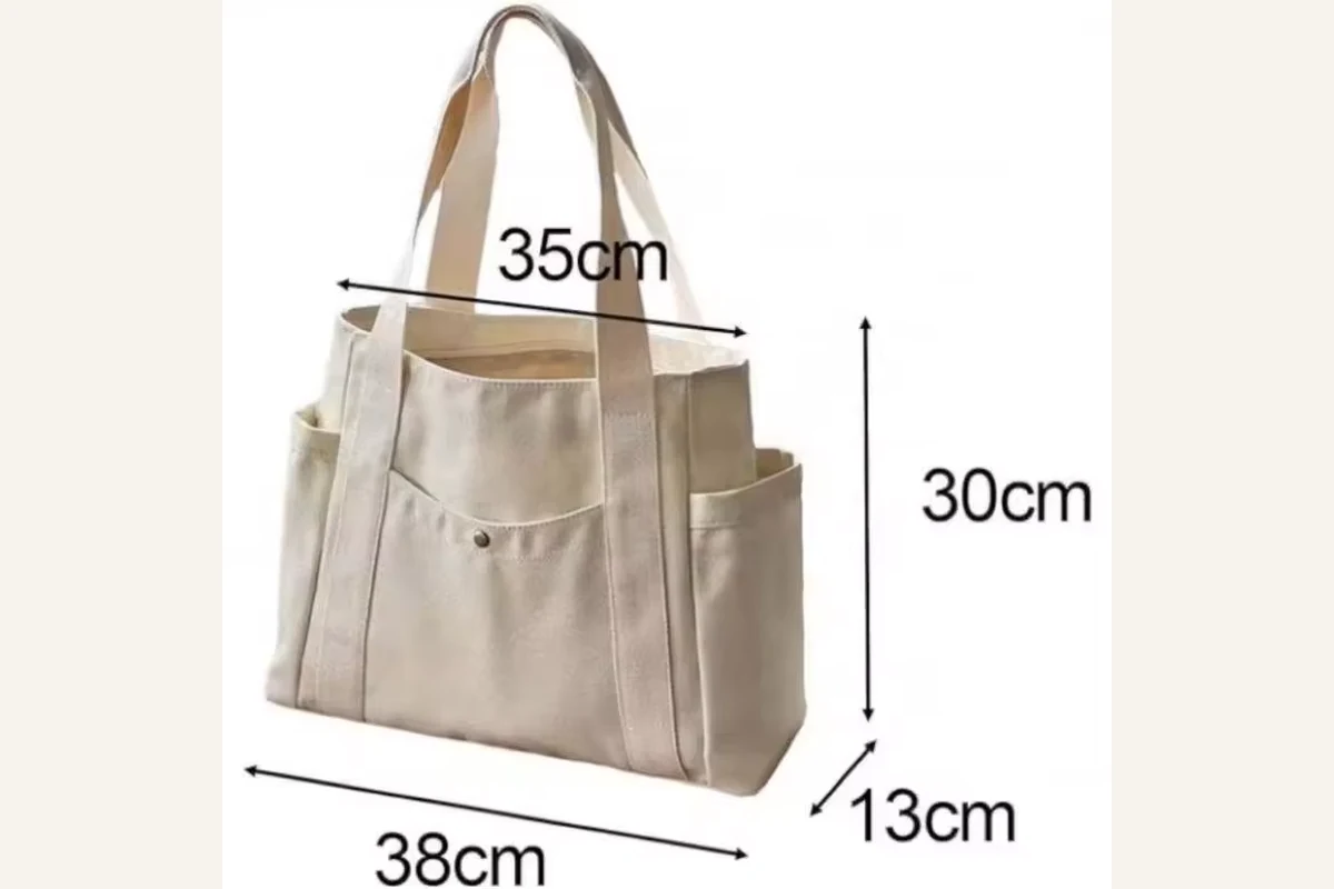 Natural cotton tote with front pockets shown with finished dimensions