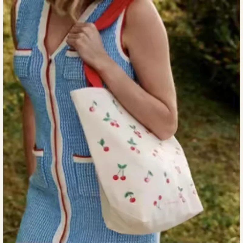 White lightweight cotton tote with a small floral pattern and long handles